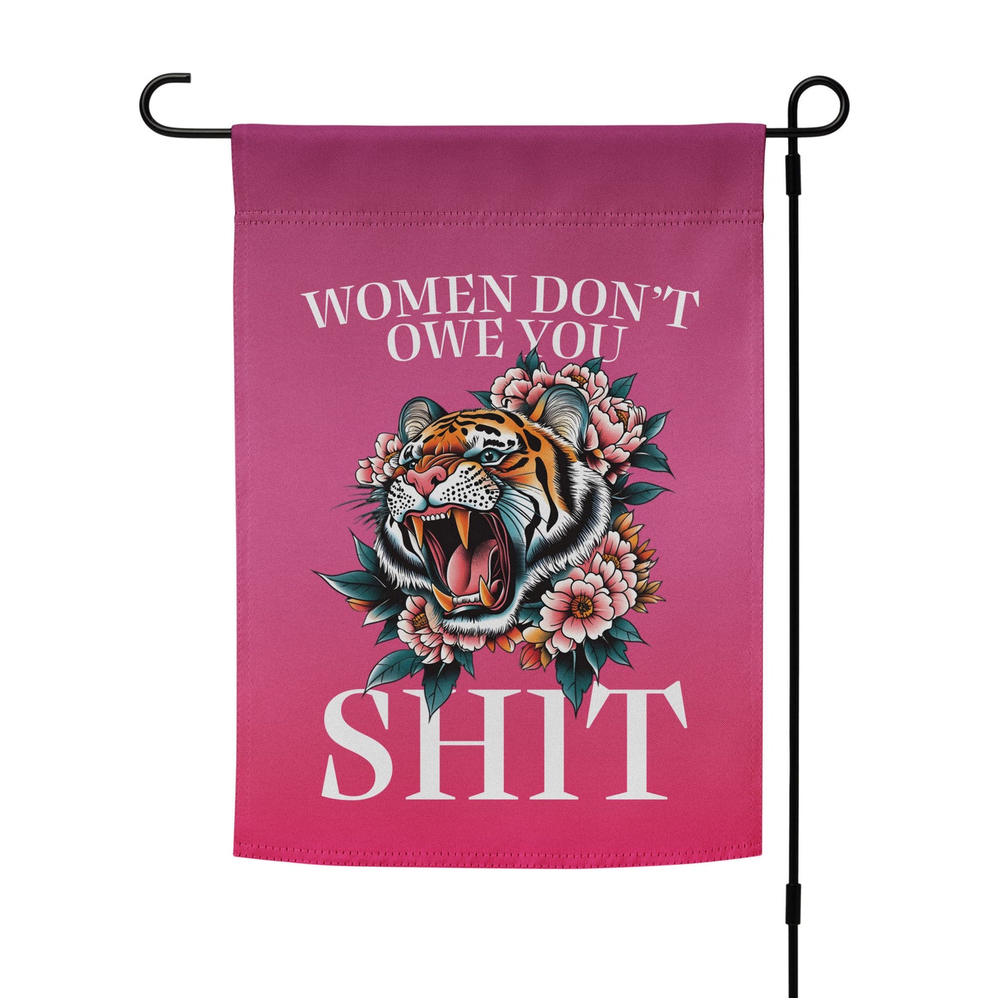 Pink garden flag displayed vertically on a black metal stand, featuring a roaring tiger with floral details and bold lettering reading “WOMEN DON’T OWE YOU SH*T,” by Blue Wave USA.