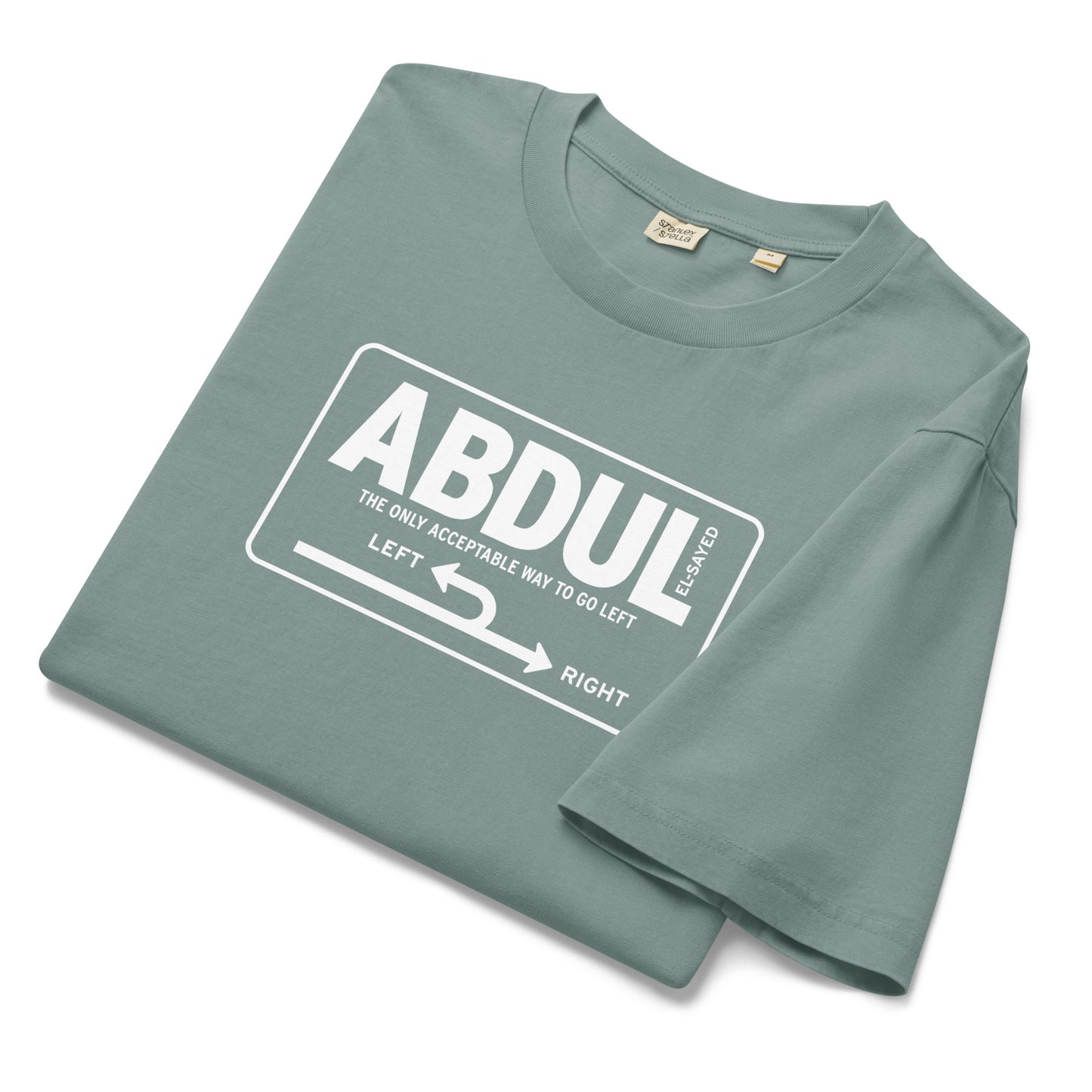 Folded sage green garment-dyed t-shirt featuring white Michigan left road sign graphic with “Abdul El-Sayed” text in retro highway-inspired design.