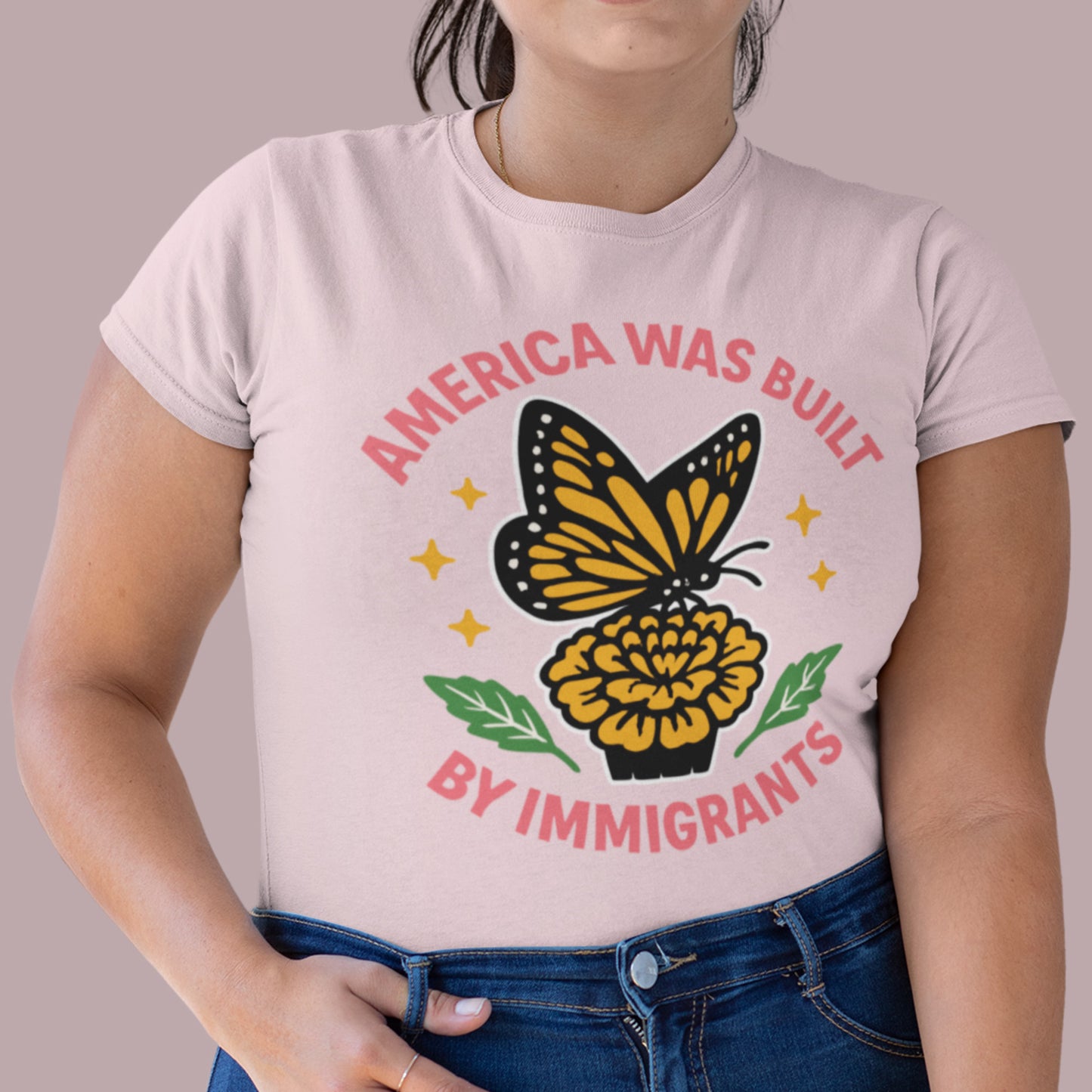 Woman wearing “America Was Built by Immigrants” butterfly graphic T-shirt, Blue Wave USA progressive women’s apparel for equality.