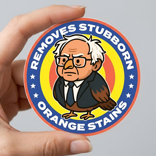 Round sticker featuring Birdie Sanders parody detergent badge with “Removes Stubborn Orange Stains” text, playful political humor activist design.