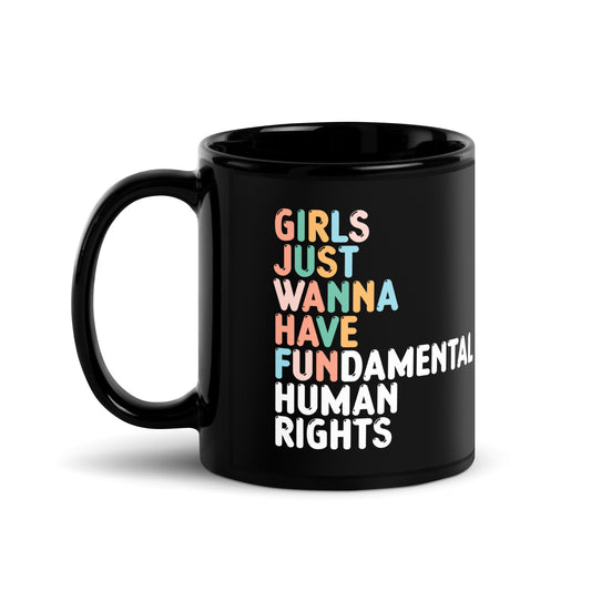11 oz Black glossy mug featuring colorful “Girls Just Wanna Have Fundamental Human Rights” typography in bold retro-inspired feminist design.