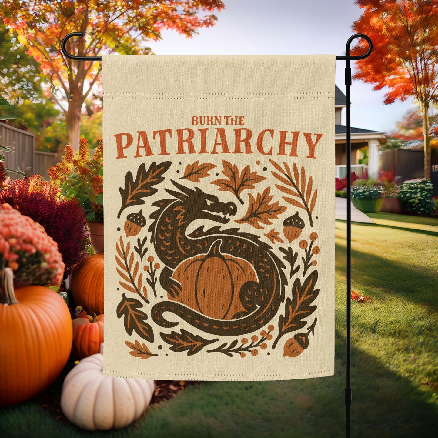 “Burn the Patriarchy” feminist dragon garden flag displayed with pumpkins and fall leaves, progressive autumn outdoor decor celebrating equality.