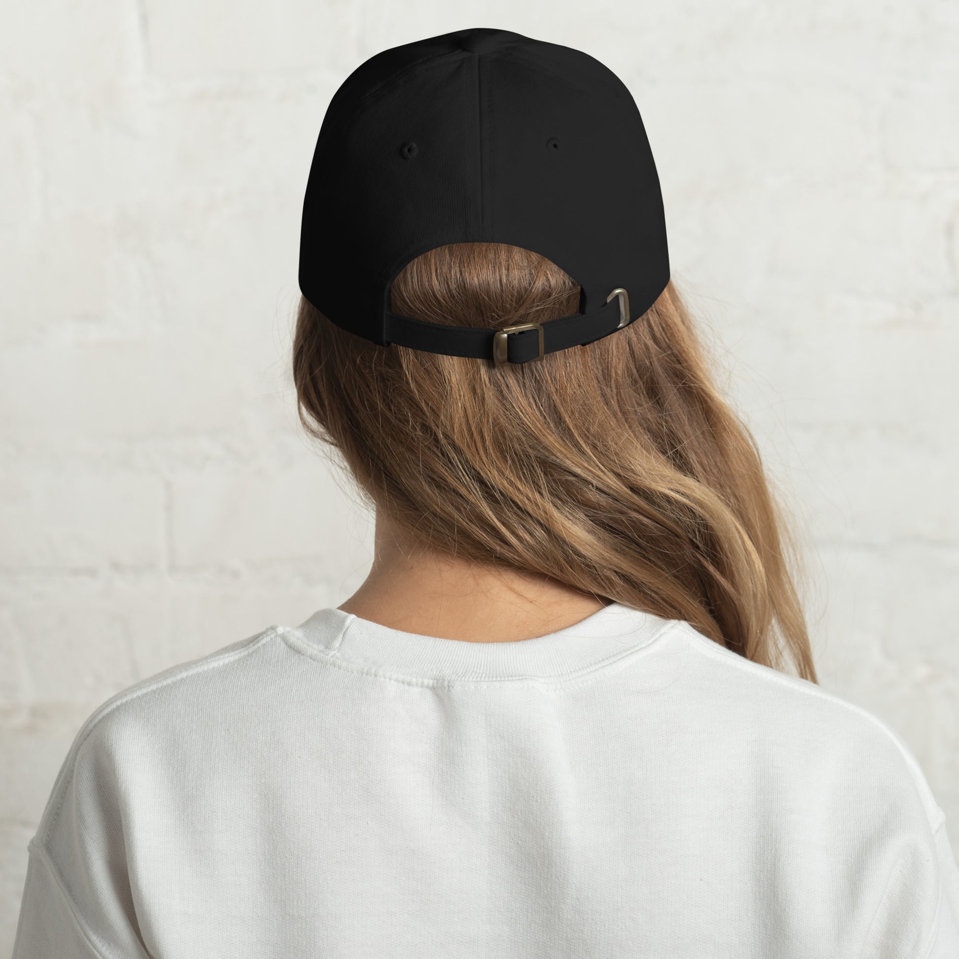 Back View Image: Back view of embroidered dad hat with “Make Good Trouble” text and golden owl
