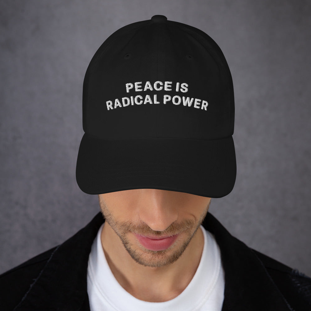 Front view: Male peace activist wearing the "Peace Is Radical Power" Anti-War Dad Hat