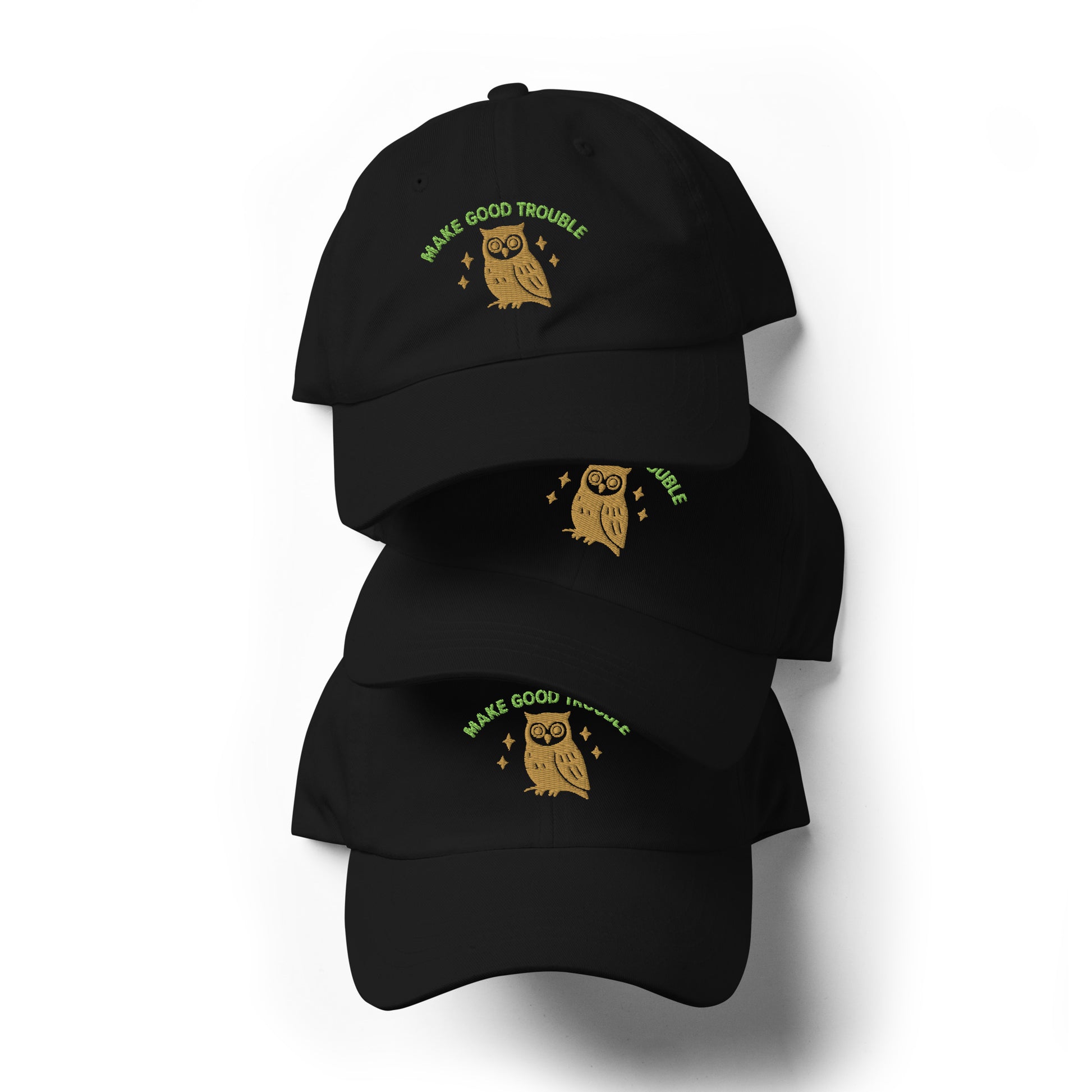 Stack of Make Good Trouble hat featuring owl and embroidered civil rights message