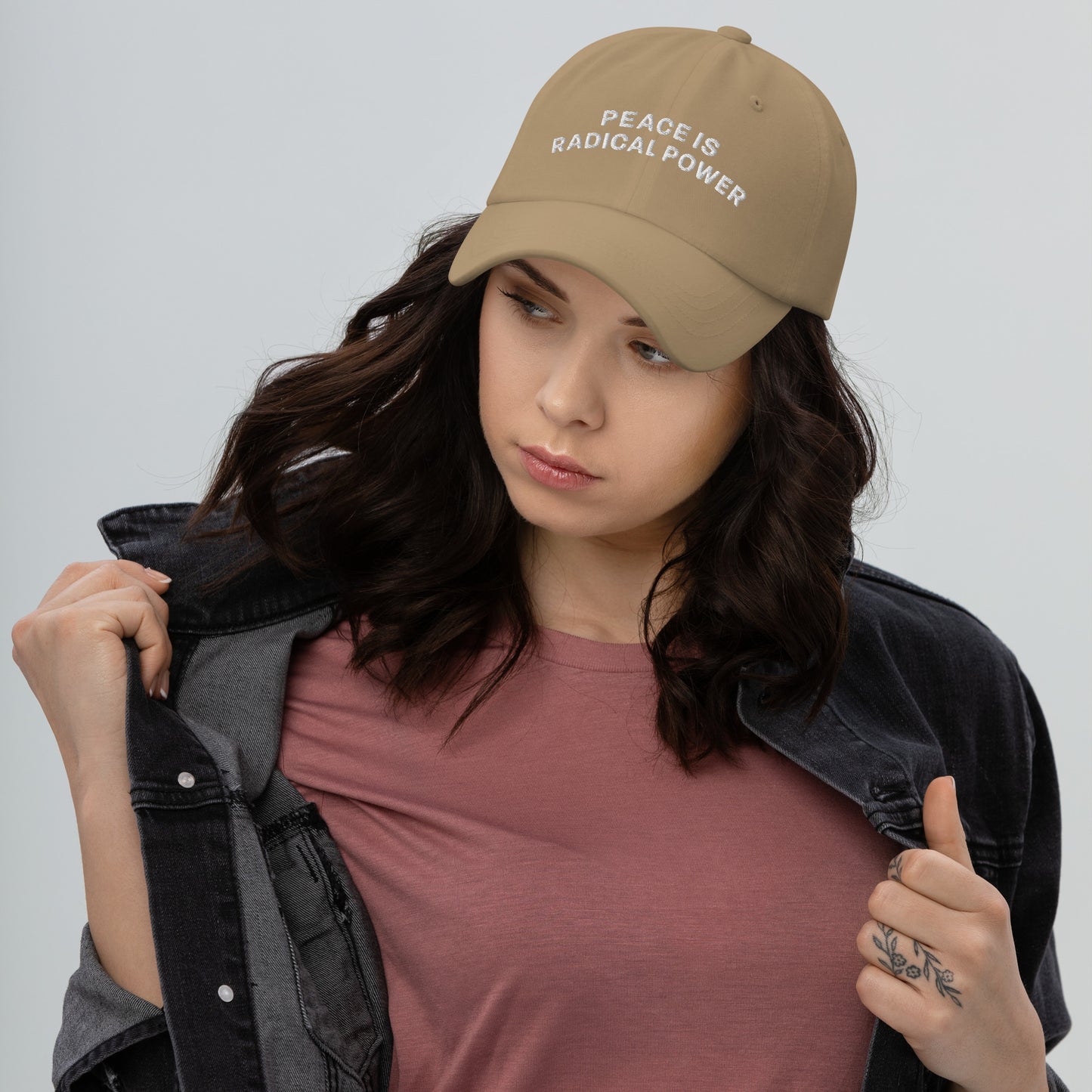 Female peace activist wearing the "Peace Is Radical Power" Anti-War Dad Hat