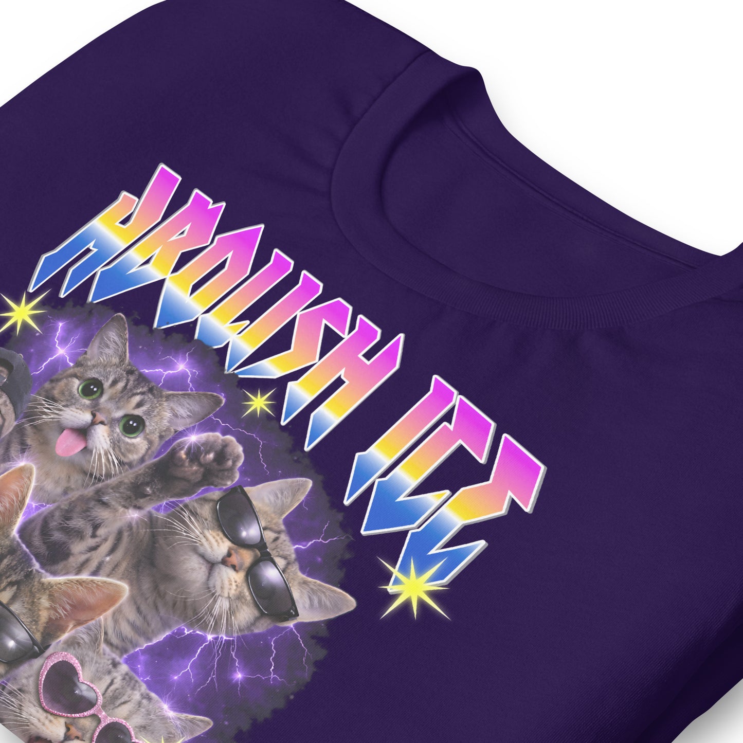 Close-up of a purple unisex t-shirt print showing illustrated cats, sunglasses, spikes, purple lightning, star accents, rainbow “ABOLISH ICE” text, and script “Get The Fuck Out.”