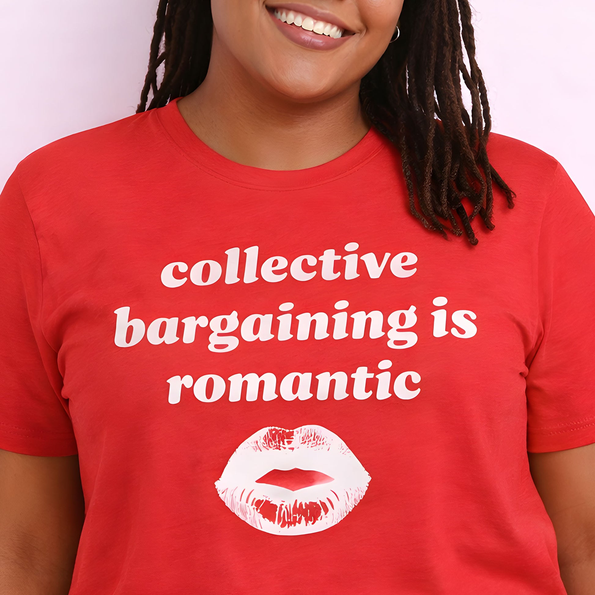 Unisex activist t-shirt worn by a model, showcasing retro white lettering and lips graphic reading “collective bargaining is romantic,” a justice-focused design supporting workers’ rights.