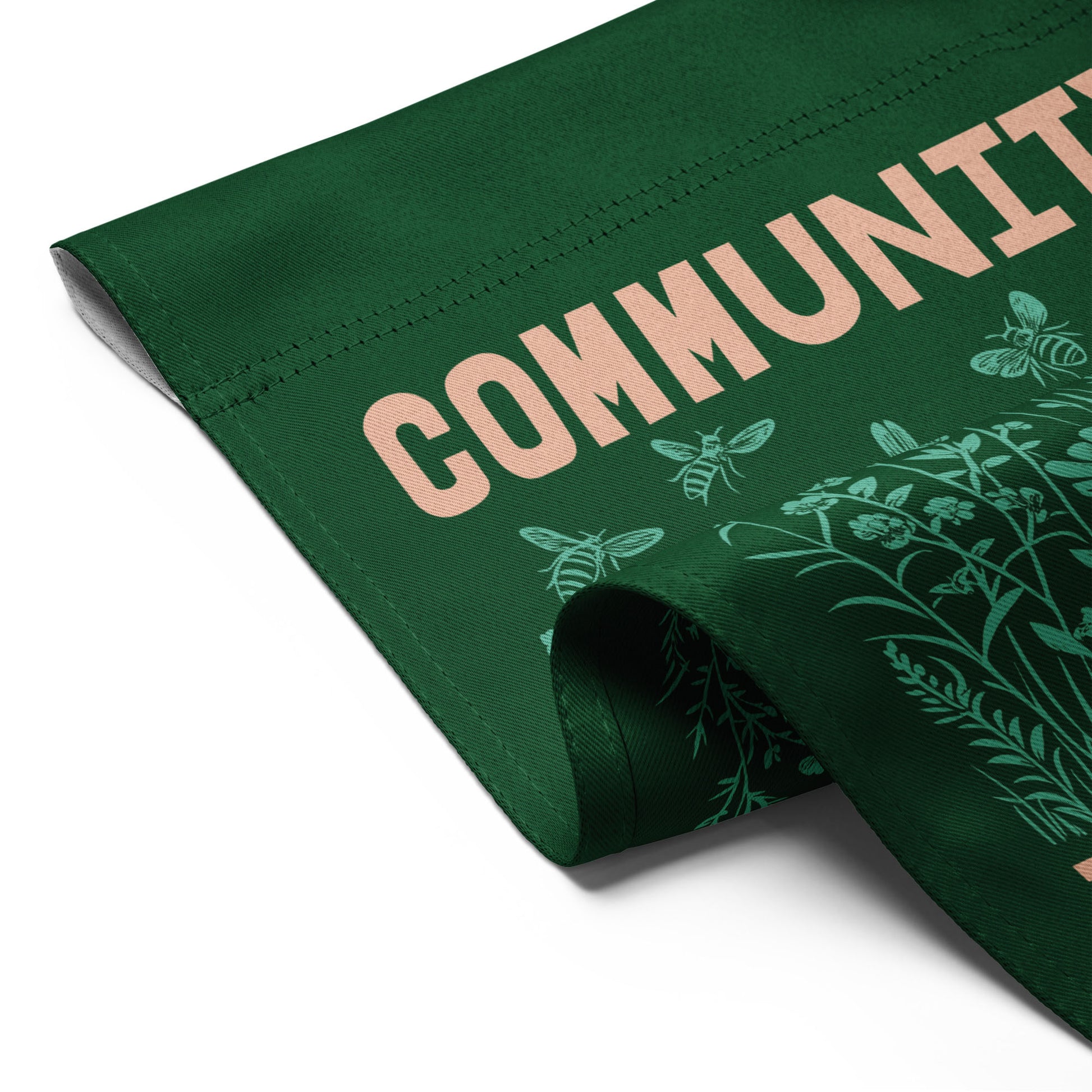 Close-up angled view of the Community Is Resistance flag corner, revealing double-sided fabric texture and clean stitching — crafted for durability and purpose by Blue Wave USA.