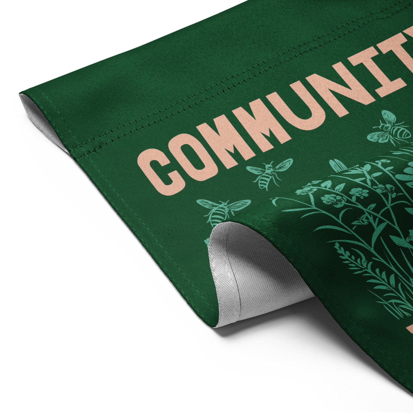 Close-up angled view of the Community Is Resistance flag corner, revealing double-sided fabric texture and clean stitching — crafted for durability and purpose by Blue Wave USA.