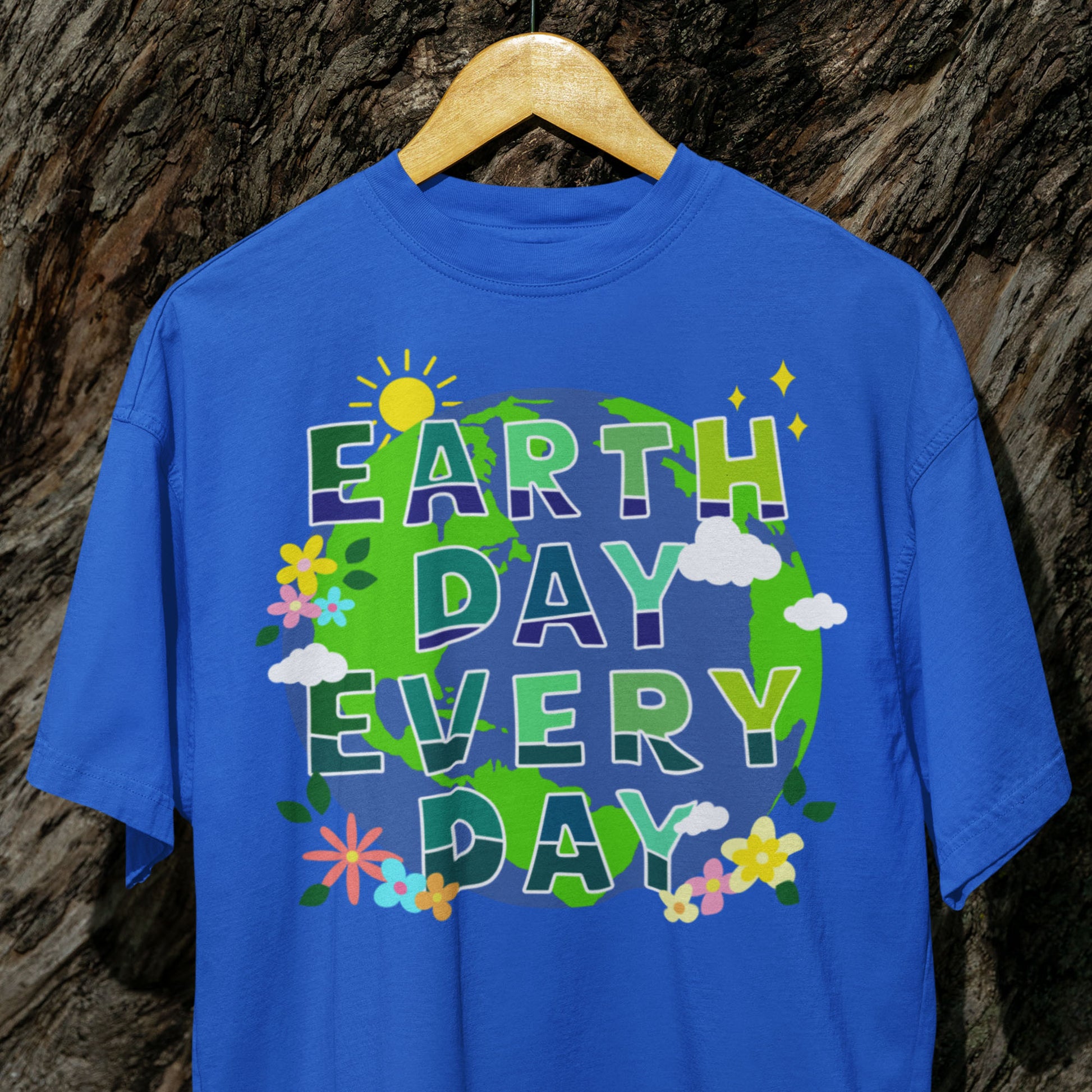 Royal Blue “Earth Day Every Day” climate change awareness t-shirt displayed on hanger outdoors.