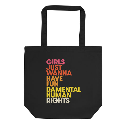 Black eco tote bag with bold stacked text in pink, orange, and yellow reading “Girls Just Wanna Have Fundamental Human Rights.”