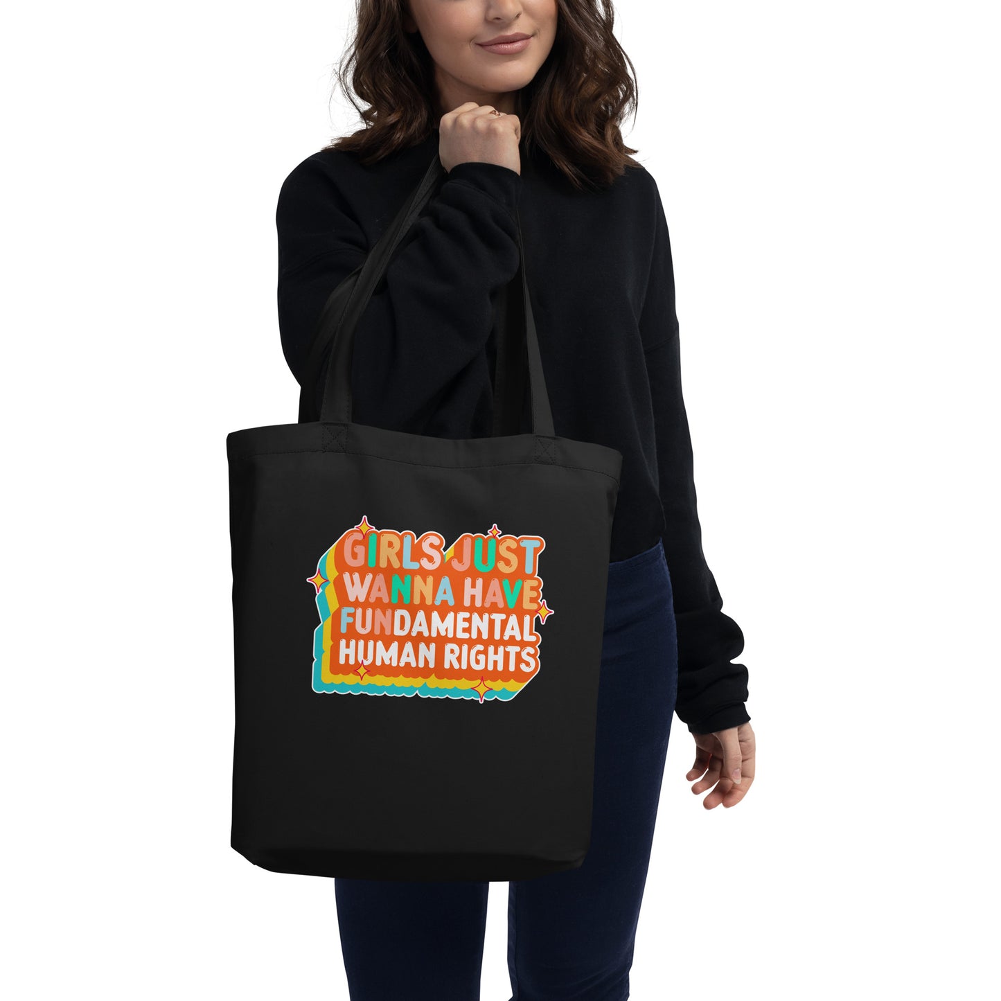 Front view of the black “Girls Just Wanna Have Fundamental Human Rights” tote, showing full colorful design centered on the bag.