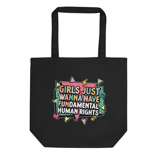 Black eco tote bag featuring the colorful retro slogan “Girls Just Wanna Have Fundamental Human Rights” with geometric accents in pink, mint, and yellow. Bold feminist statement tote celebrating equality.