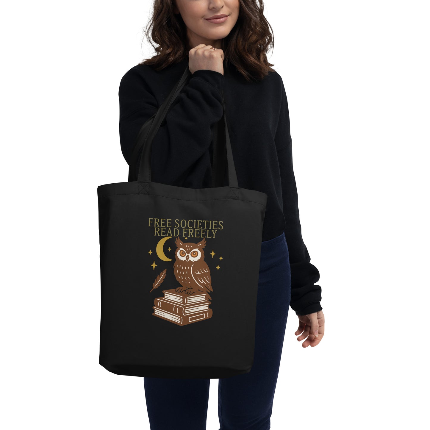 Model carrying black “Free Societies Read Freely” tote bag featuring owl and books artwork. Progressive Blue Wave USA statement bag.