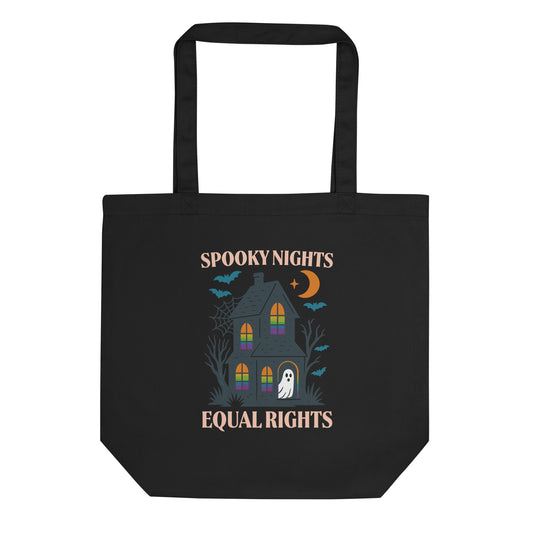 Black tote bag with a haunted house, ghost, bats, and crescent moon design featuring the phrase “Spooky Nights Equal Rights.” Progressive Halloween eco tote by Blue Wave USA.