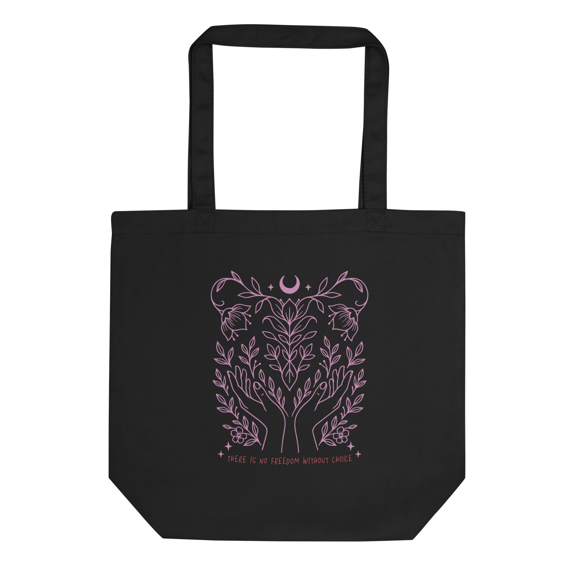 Black eco tote bag featuring a soft pink botanical line art design with hands, vines, and a crescent moon above the phrase “There Is No Freedom Without Choice.”