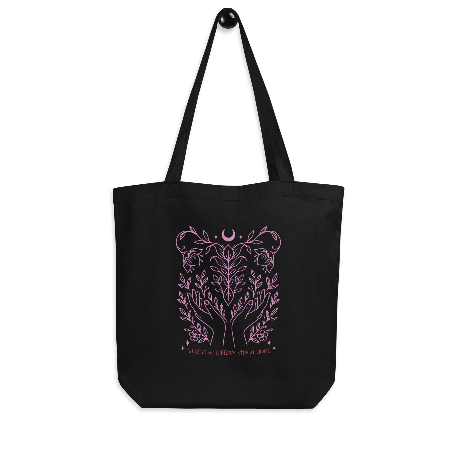 Front view of the “There Is No Freedom Without Choice” eco tote bag hanging, showing full pink celestial and floral illustration. Feminist pro-choice design by Blue Wave USA.