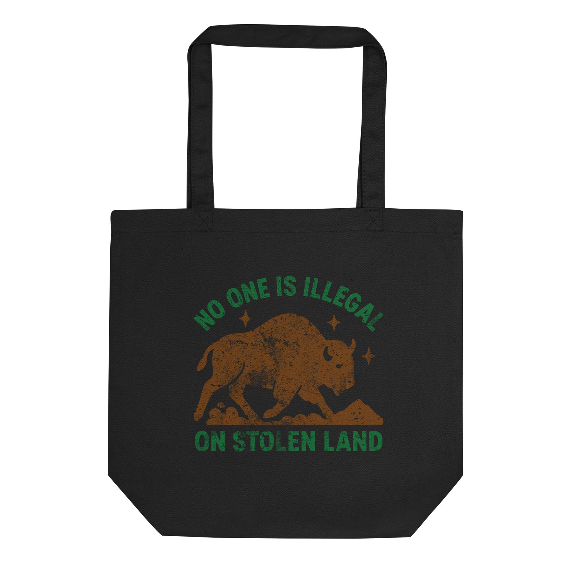 Black tote bag featuring a textured buffalo illustration and the printed message “NO ONE IS ILLEGAL ON STOLEN LAND,” an Indigenous rights–themed reusable bag by Blue Wave USA.