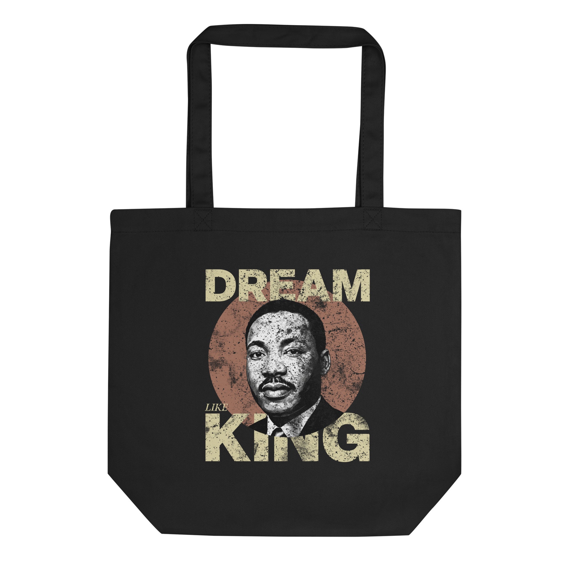 Black eco tote bag featuring the distressed “DREAM LIKE KING” design with Martin Luther King Jr.’s portrait inside a textured circle. Vintage civil-rights inspired artwork from Blue Wave USA.