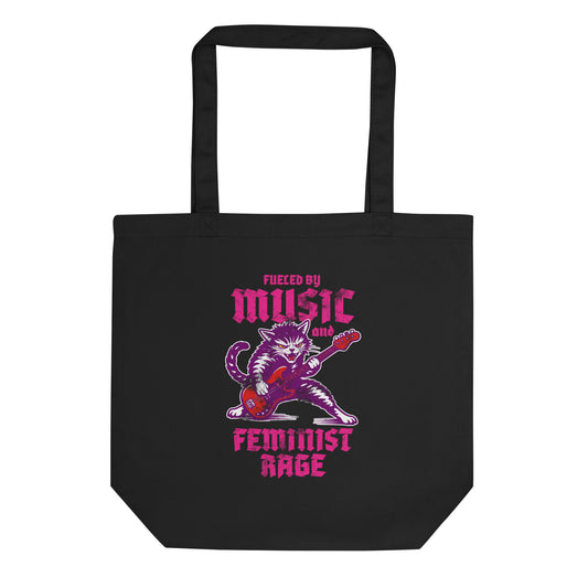 Black eco tote bag featuring a punk rock cat playing electric guitar with bold gothic lettering reading “FUELED BY MUSIC AND FEMINIST RAGE,” vibrant purple and pink graphic centered.