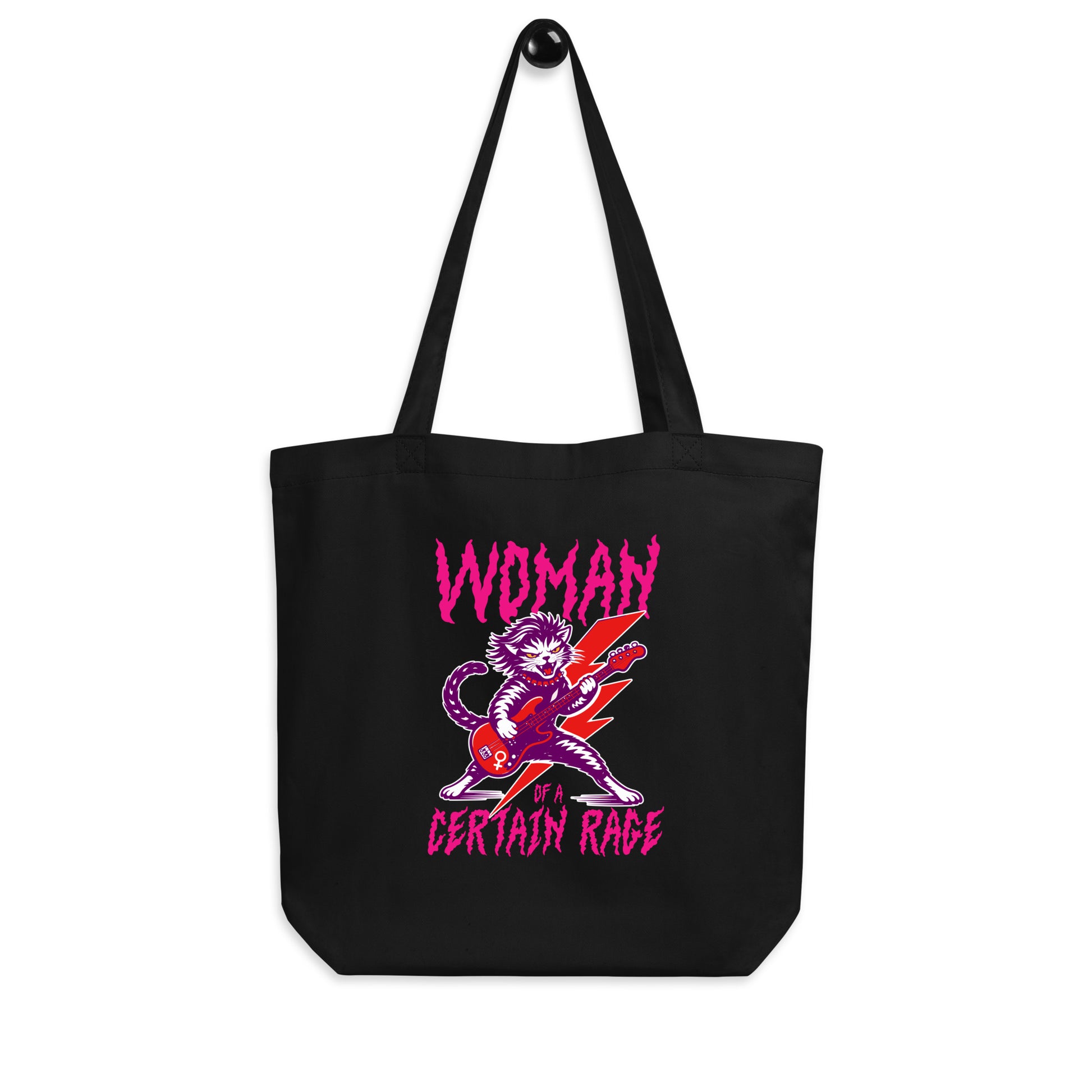 Black eco tote bag displayed on a white background, showcasing the punk rock cat guitar illustration and distressed text reading “WOMAN OF A CERTAIN RAGE,” from Blue Wave USA.