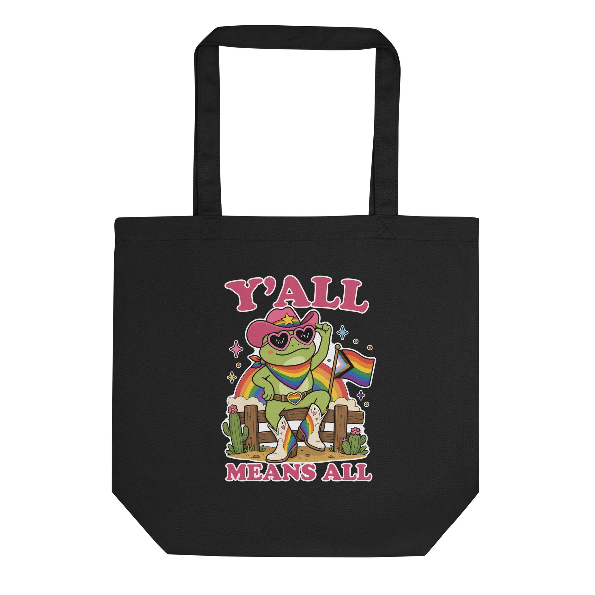 Black eco tote bag featuring a rainbow cowboy frog in heart-shaped sunglasses holding a pride flag with bold “Y’All Means All” LGBTQ+ pride artwork.