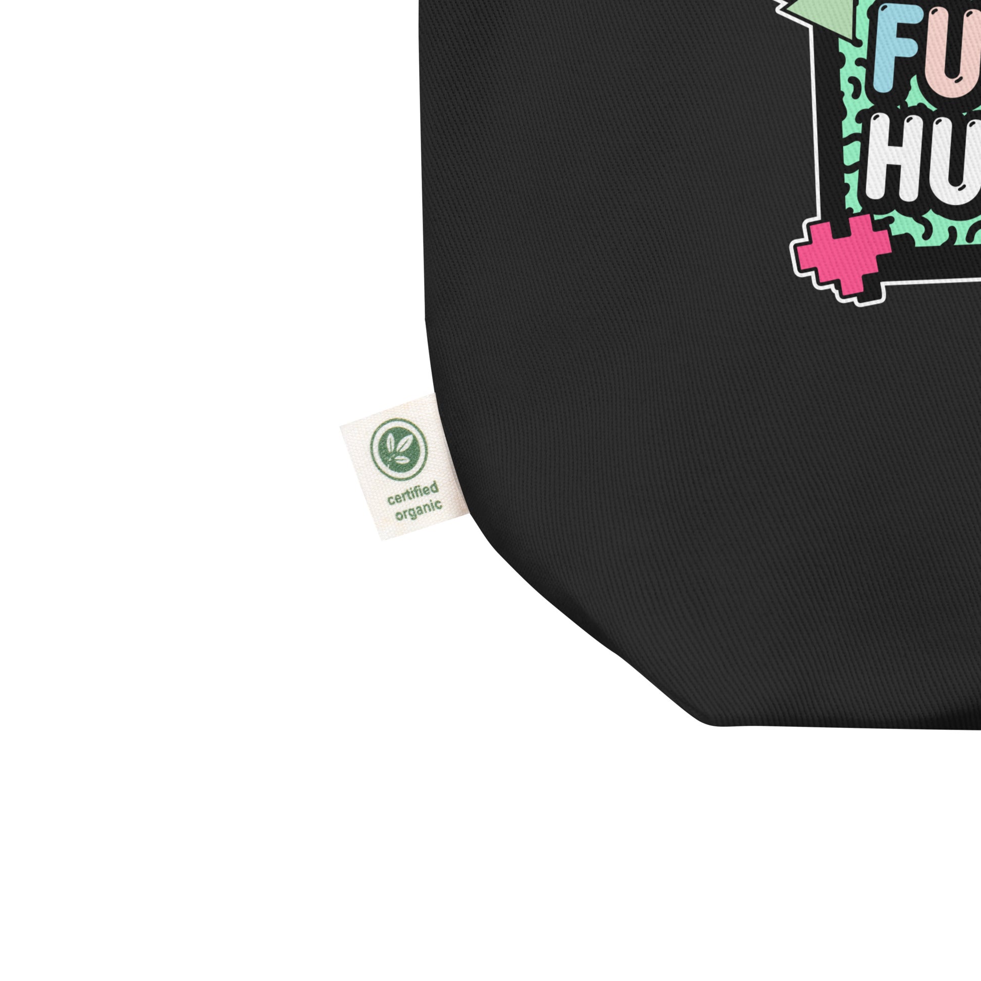Close-up of the eco tote showing part of the “Girls Just Wanna Have Fundamental Human Rights” design and green eco label. Sustainable activism accessory by Blue Wave USA.