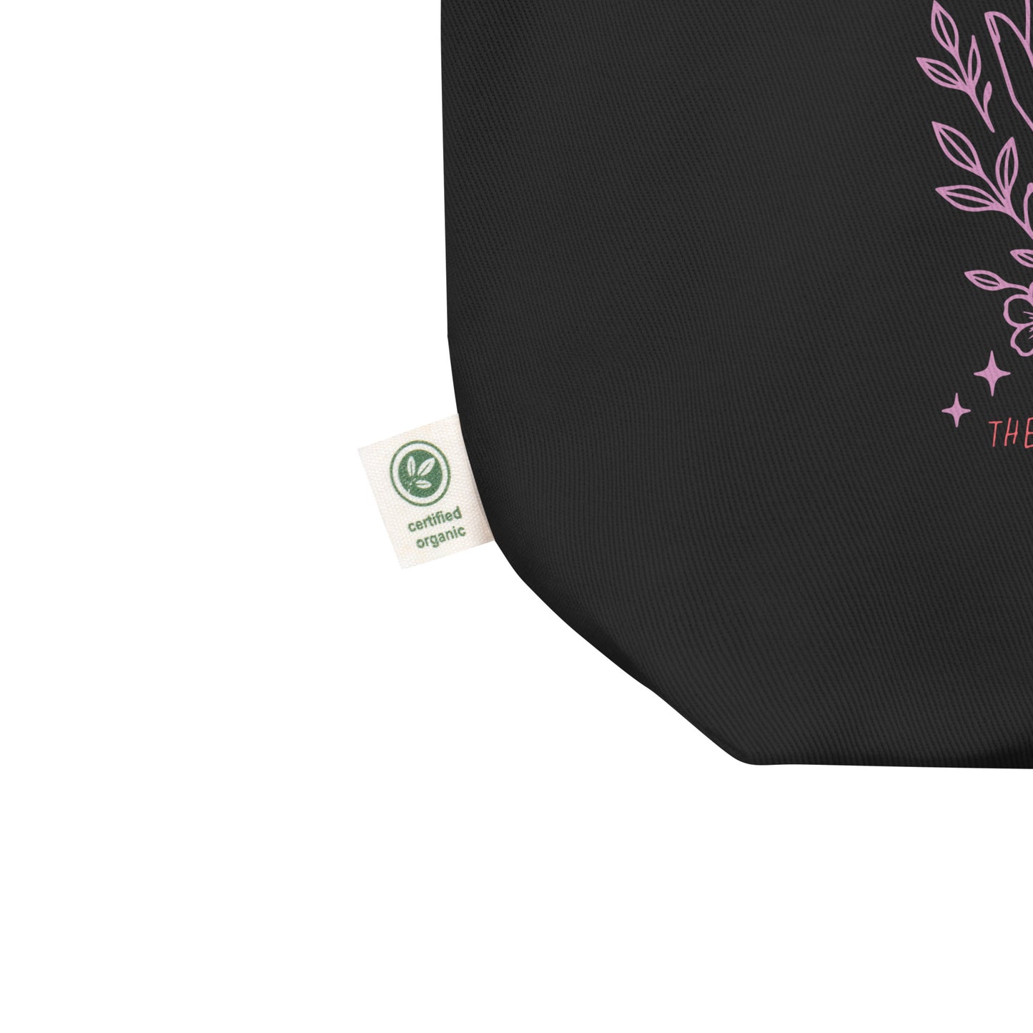 Close-up of the organic cotton tote corner showing certified eco label and part of the pink artwork. Ethically made sustainable bag by Blue Wave USA.