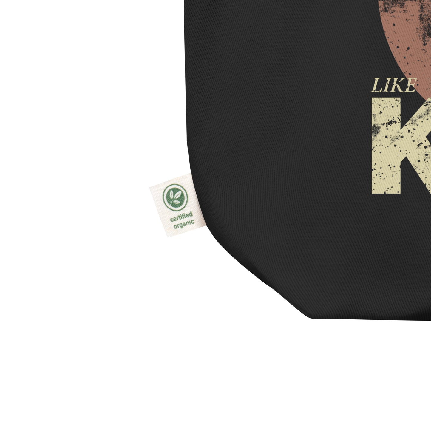 Close-up of the black eco tote bag’s bottom corner showing stitching and part of the distressed “DREAM LIKE KING” graphic with MLK’s portrait. Minimal vintage civil-rights detail.