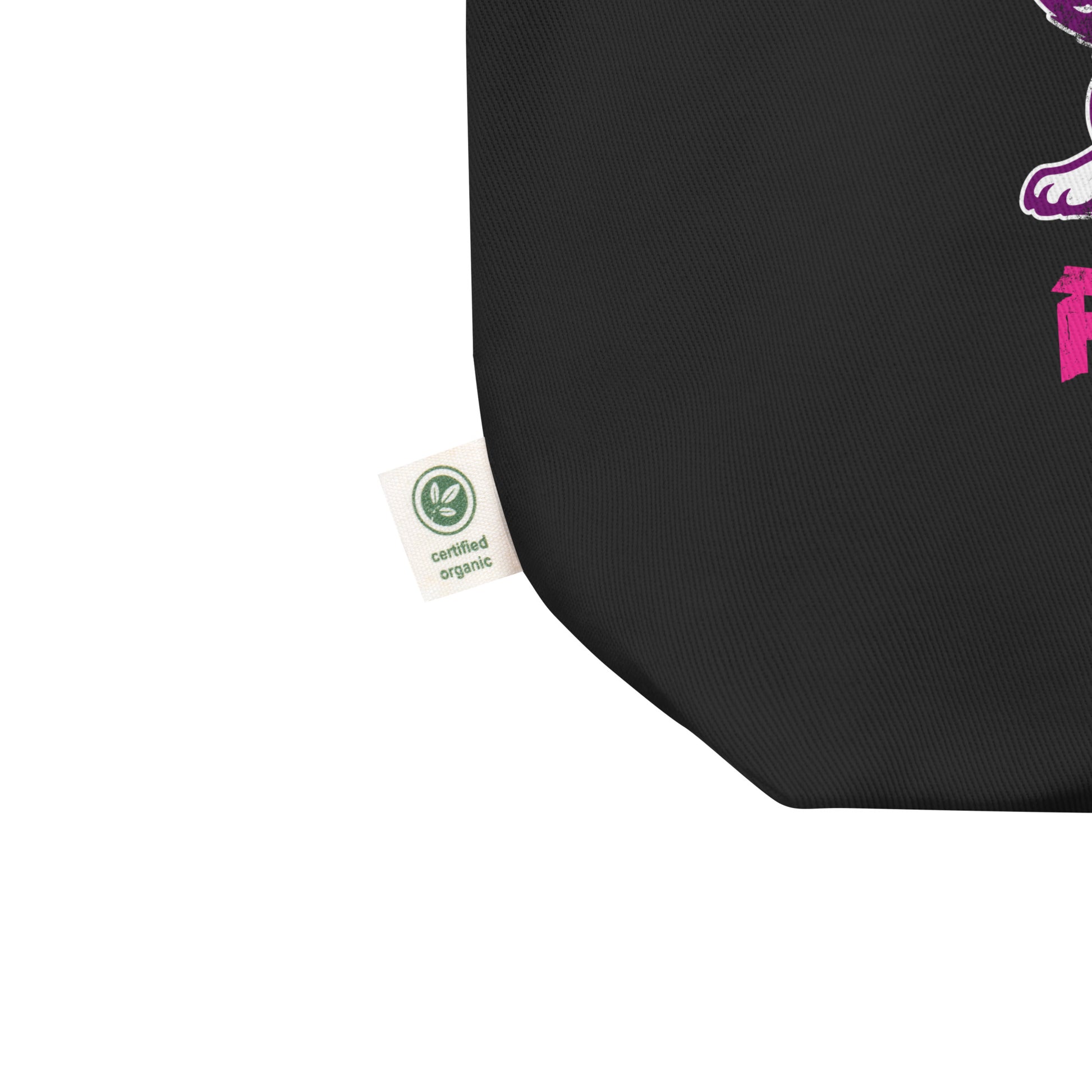 Close-up of the lower corner of a black eco tote bag showing fabric texture and interior label, with partial view of the punk rock cat feminist graphic.