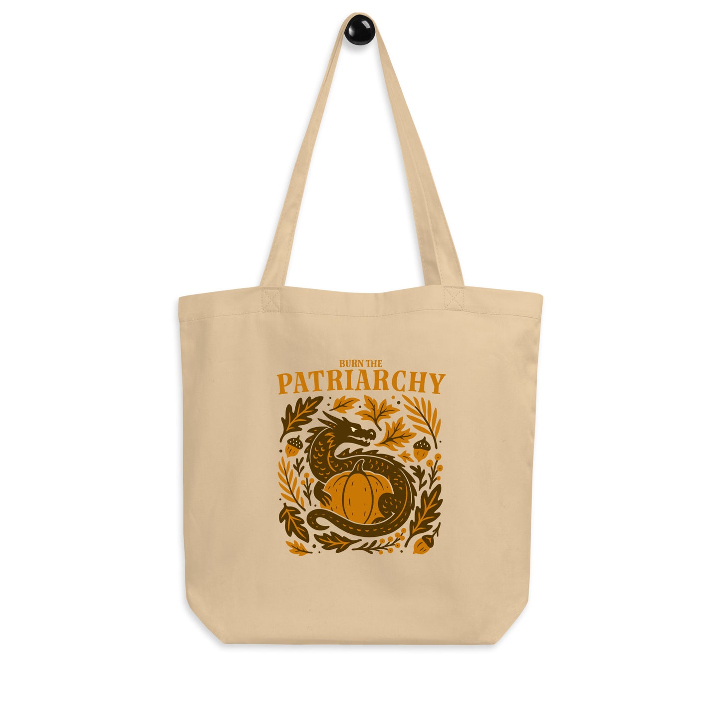 Hanging beige “Burn the Patriarchy” feminism dragon tote, autumn equality bag with folk-art botanical details.