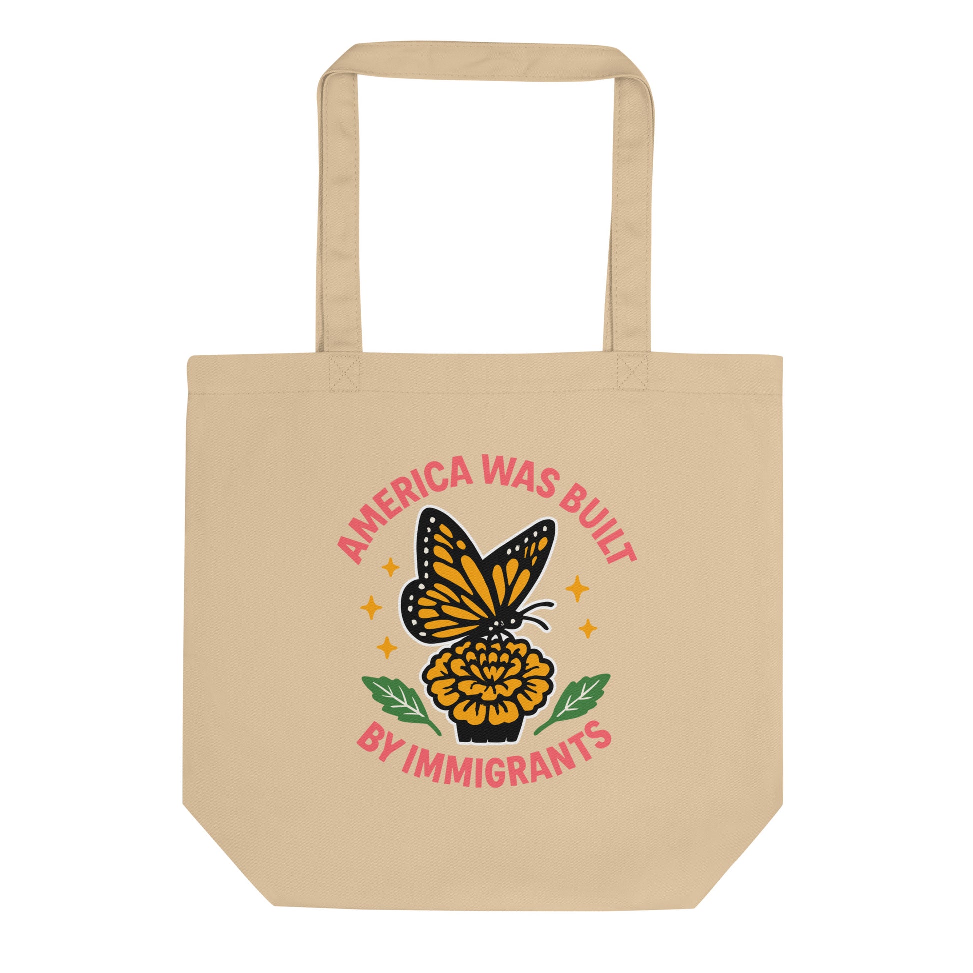 Natural eco tote bag with bold butterfly and marigold design reading “America Was Built by Immigrants.” Immigration justice tote by Blue Wave USA.