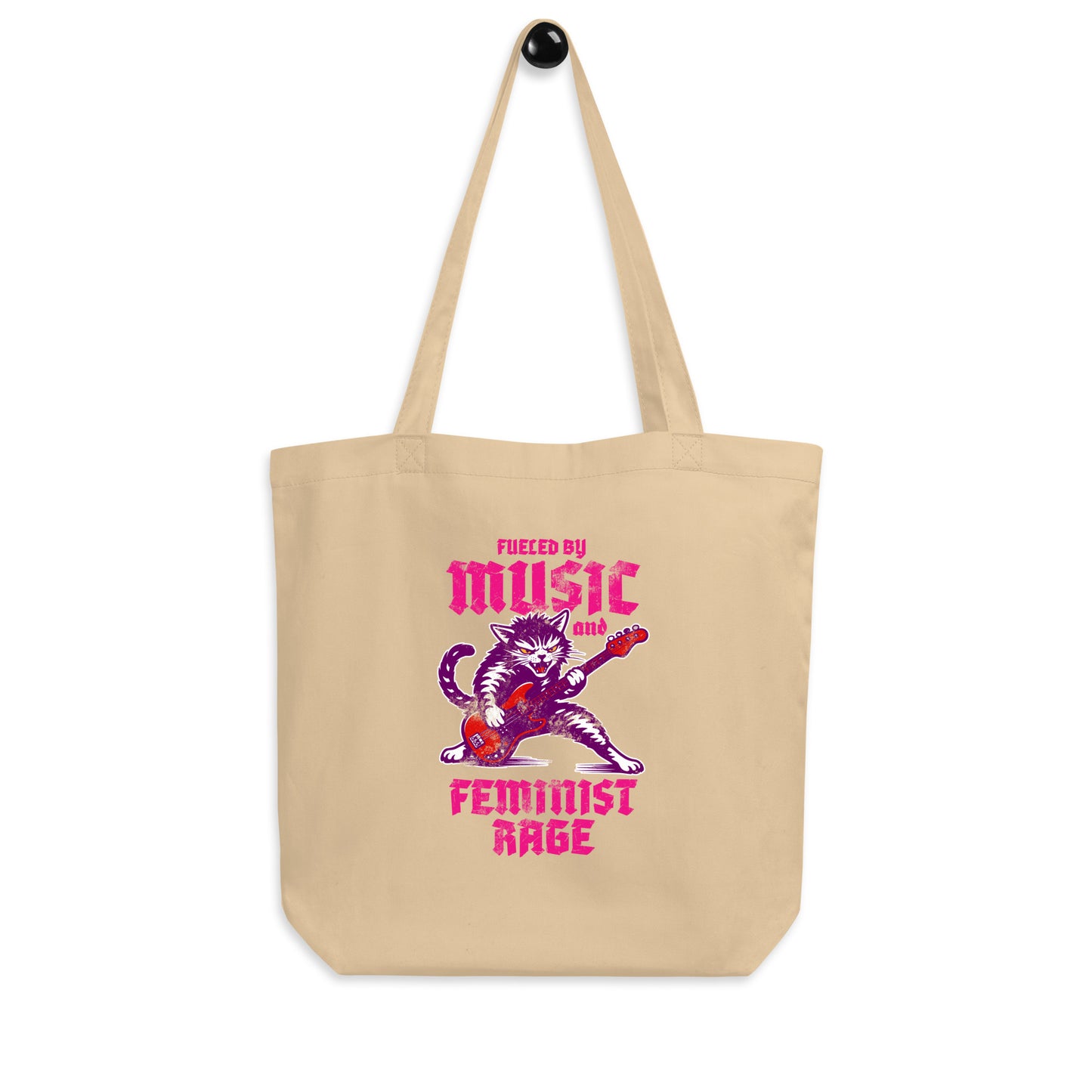 Natural canvas eco tote bag displayed flat, featuring a punk rock cat playing electric guitar with bold gothic lettering reading “FUELED BY MUSIC AND FEMINIST RAGE.”