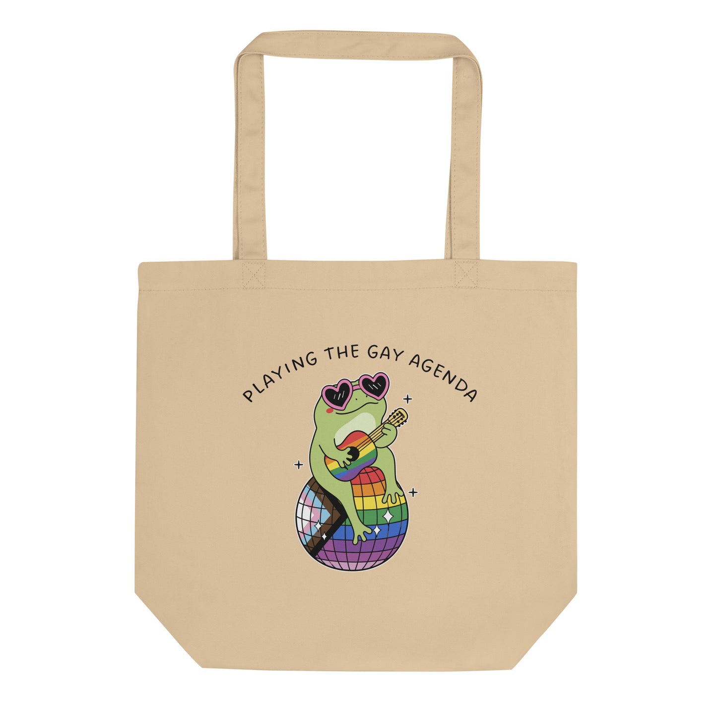 Natural canvas tote bag featuring a disco frog seated on a rainbow disco ball with “Playing the Gay Agenda” text and colorful pride-themed artwork.