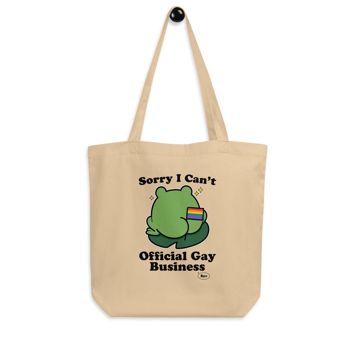 Natural cotton tote bag showcasing a playful frog illustration with rainbow flag detail and “Sorry I Can’t. Official Gay Business. Bye.” typography.