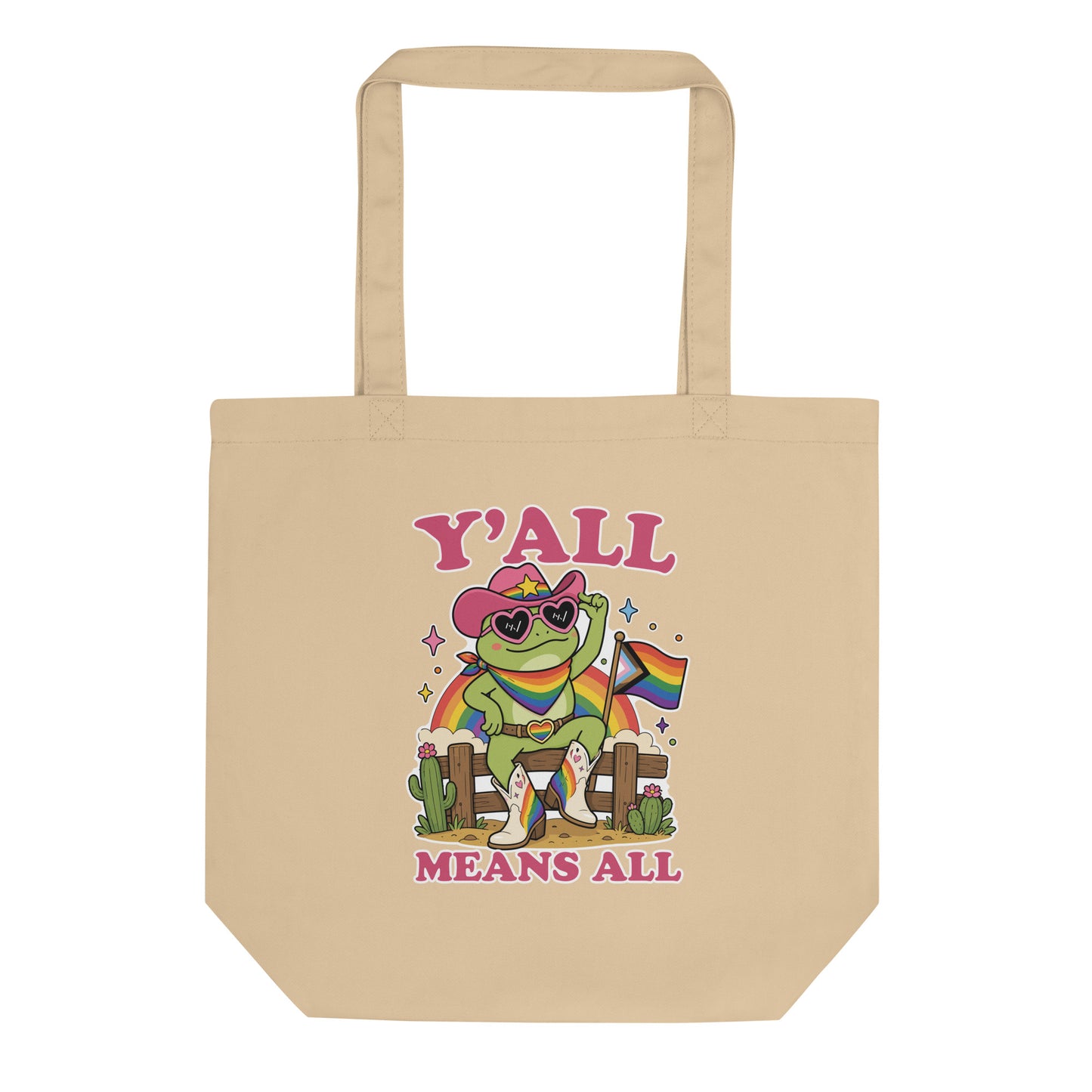 Natural reusable tote bag showcasing a rainbow cowboy frog in heart-shaped sunglasses with western-inspired pride artwork and welcoming “Y’All Means All” message.