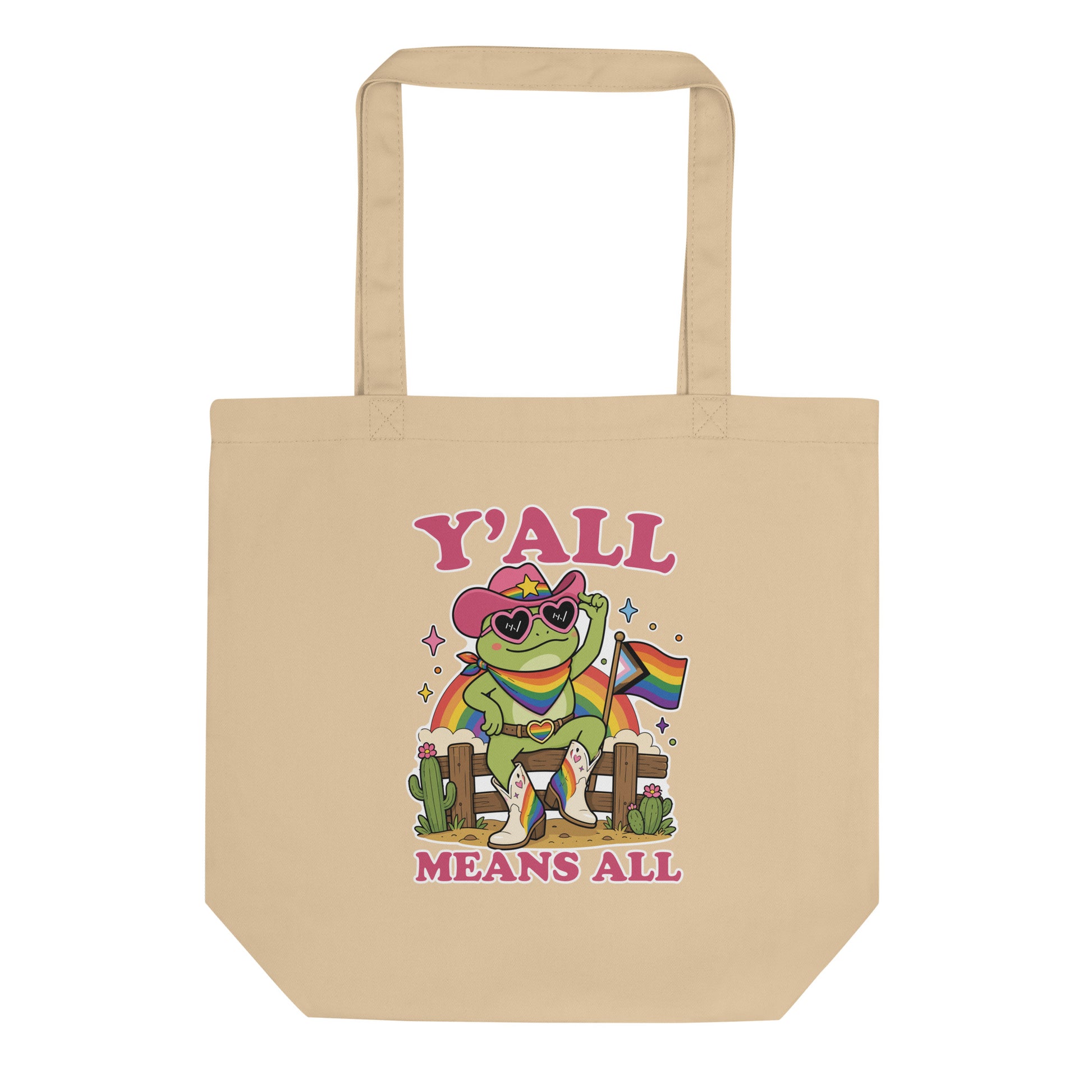 Natural reusable tote bag showcasing a rainbow cowboy frog in heart-shaped sunglasses with western-inspired pride artwork and welcoming “Y’All Means All” message.