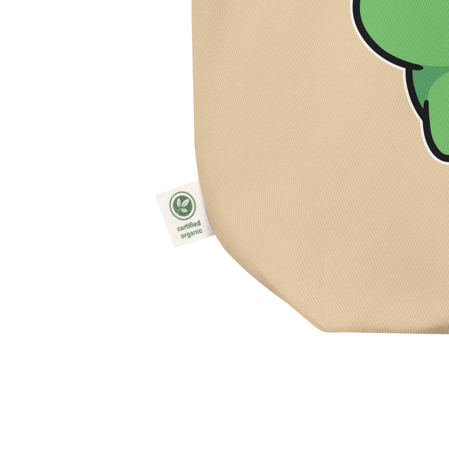 Close-up eco tote corner showing natural canvas texture with partial frog graphic and visible gas cloud detail from protest design.