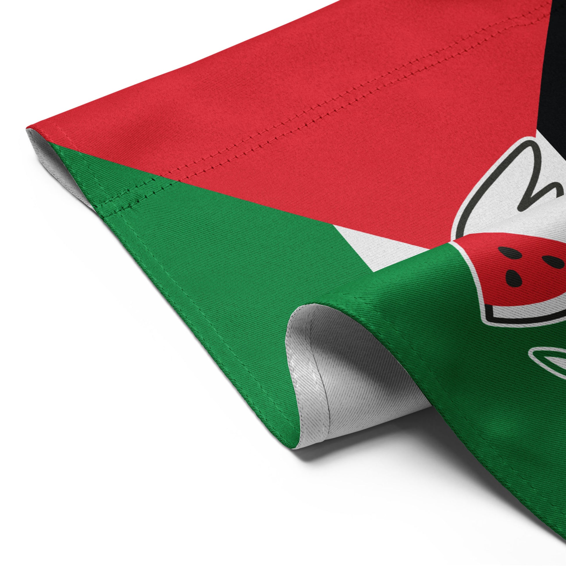 Detailed folded view of the Free Palestine solidarity garden flag with red, white, green, and black colors, and dove holding olive branch.