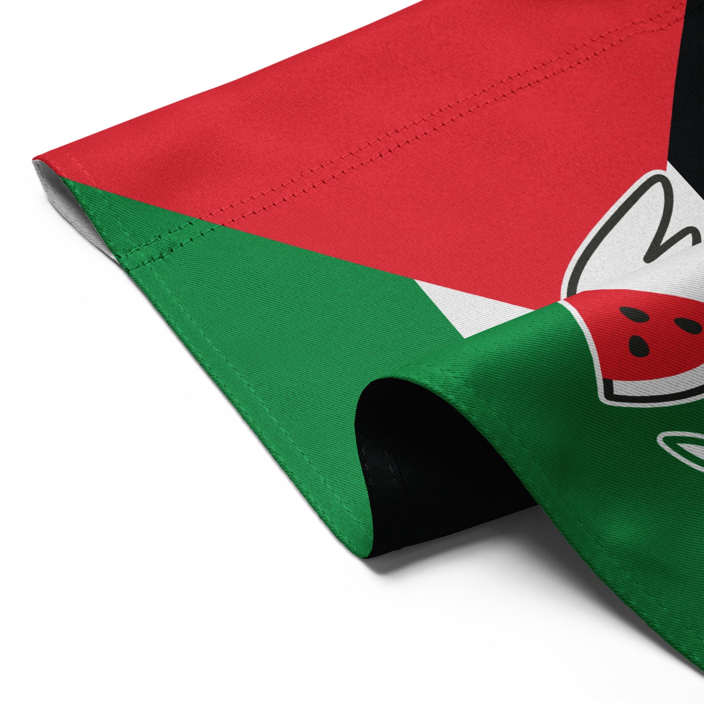 Detailed folded view of the Free Palestine solidarity garden flag with red, white, green, and black colors, and dove holding olive branch.