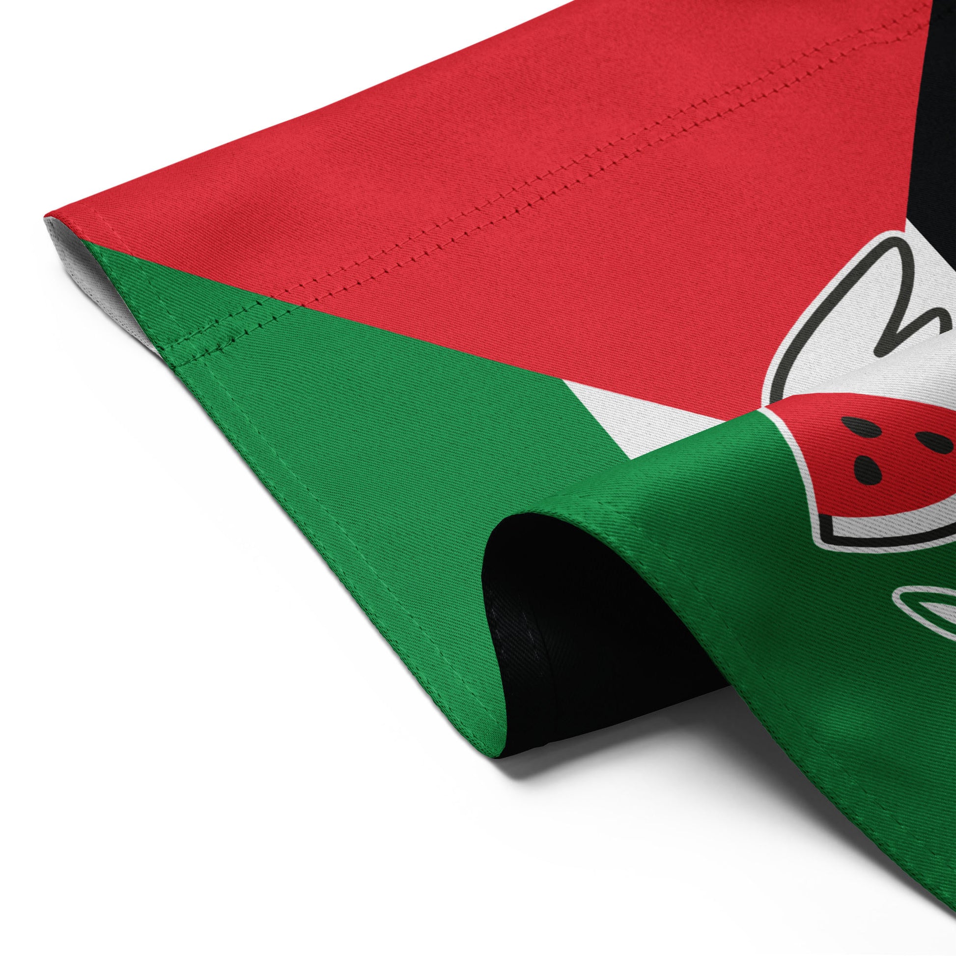 Detailed folded view of the Free Palestine solidarity garden flag with red, white, green, and black colors, and dove holding olive branch.