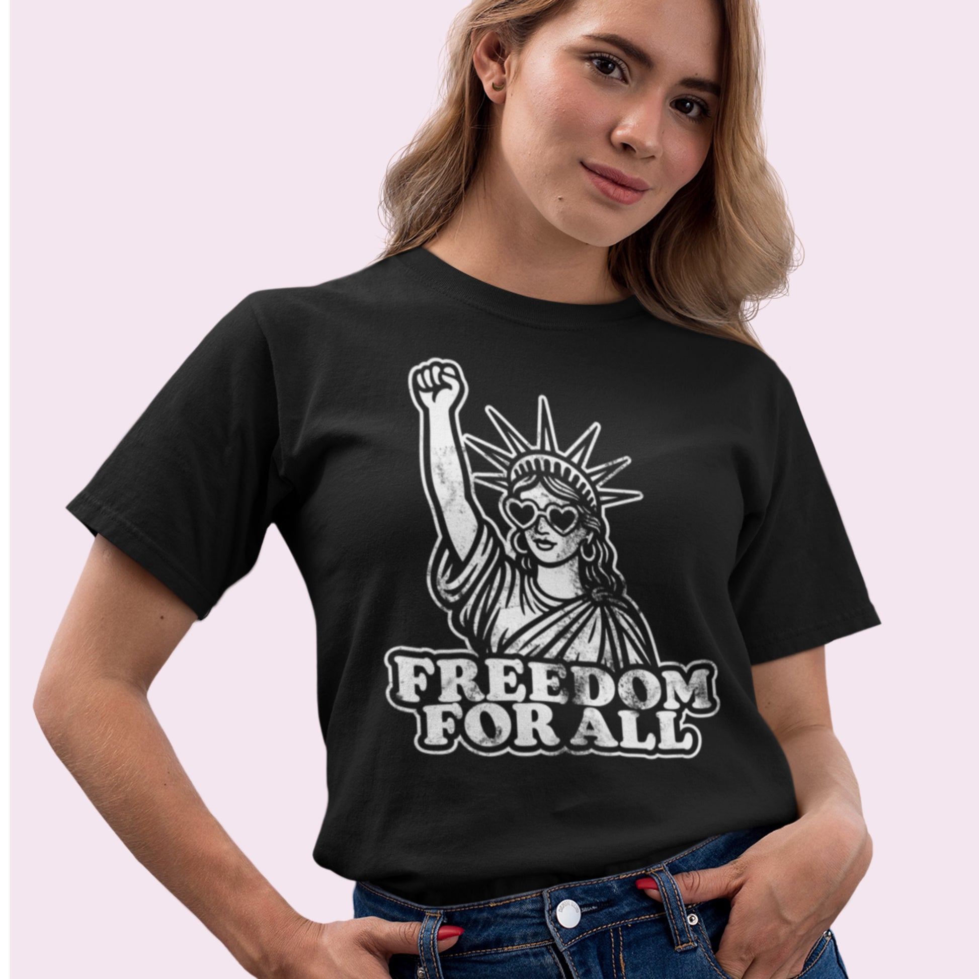 Person wearing a black Freedom for All t-shirt paired with jeans, hands at the waist. A sleek activist look from Blue Wave USA, standing for liberty and solidarity.