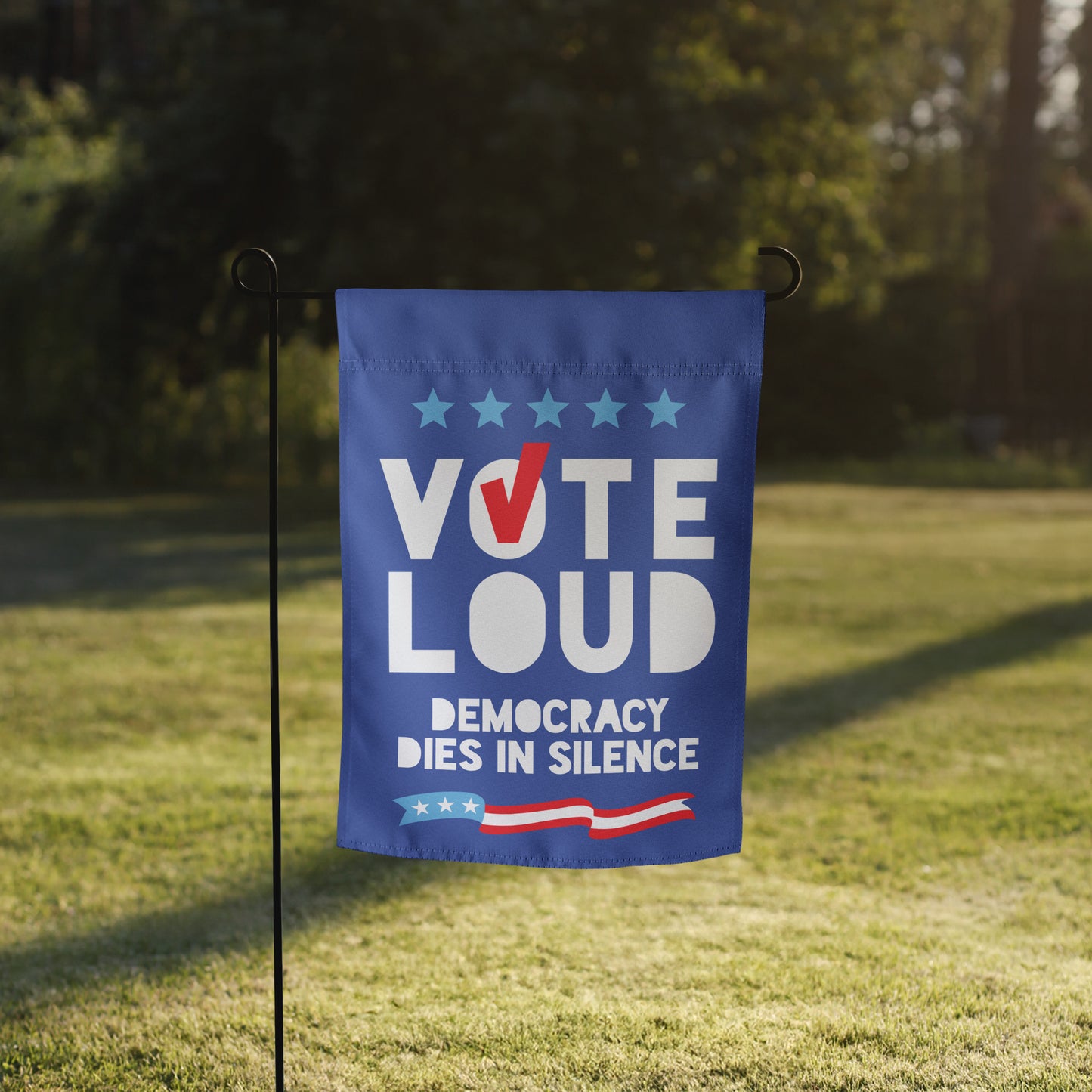 Blue Wave USA garden flag displayed on lawn, showcasing “VOTE LOUD” typography and democracy message in patriotic election-season yard decor styling.