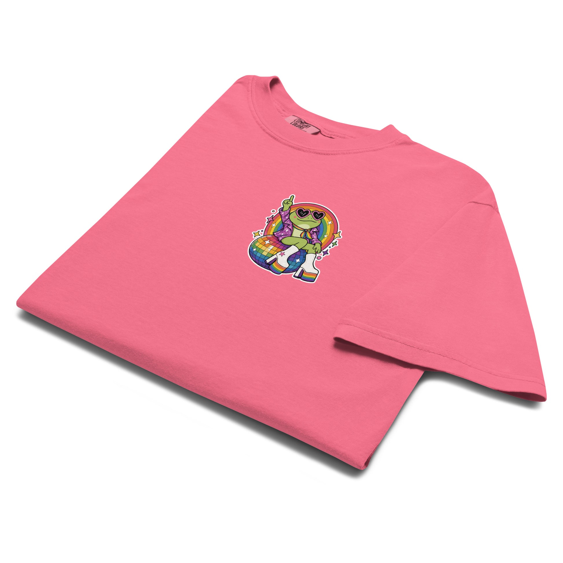Folded berry garment-dyed t-shirt showcasing a small chest version of the colorful disco frog Pride graphic inspired by LGBTQ+ celebration and retro dance culture.