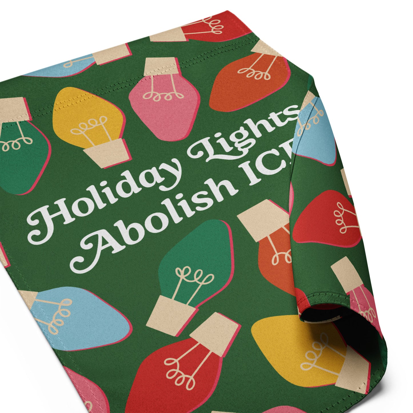 A folded view of the green garden flag showing the illustrated bulbs and typography from “Holiday Lights Abolish ICE,” highlighting print quality and cheerful seasonal activism.