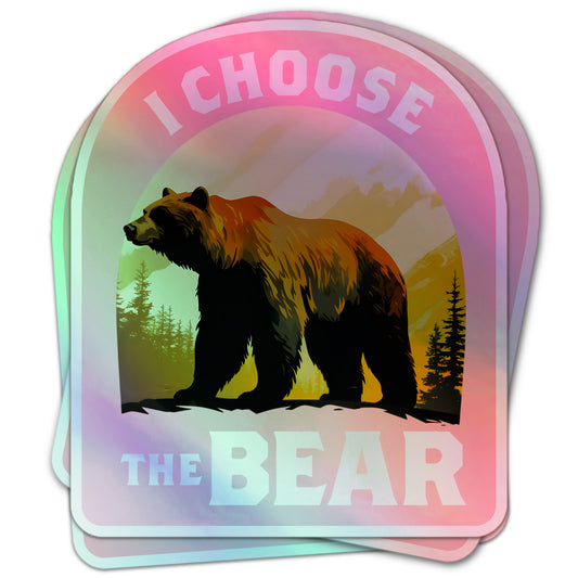 Feminist empowerment sticker with a brown bear in front of pine trees and mountains, reading “I Choose The Bear.”