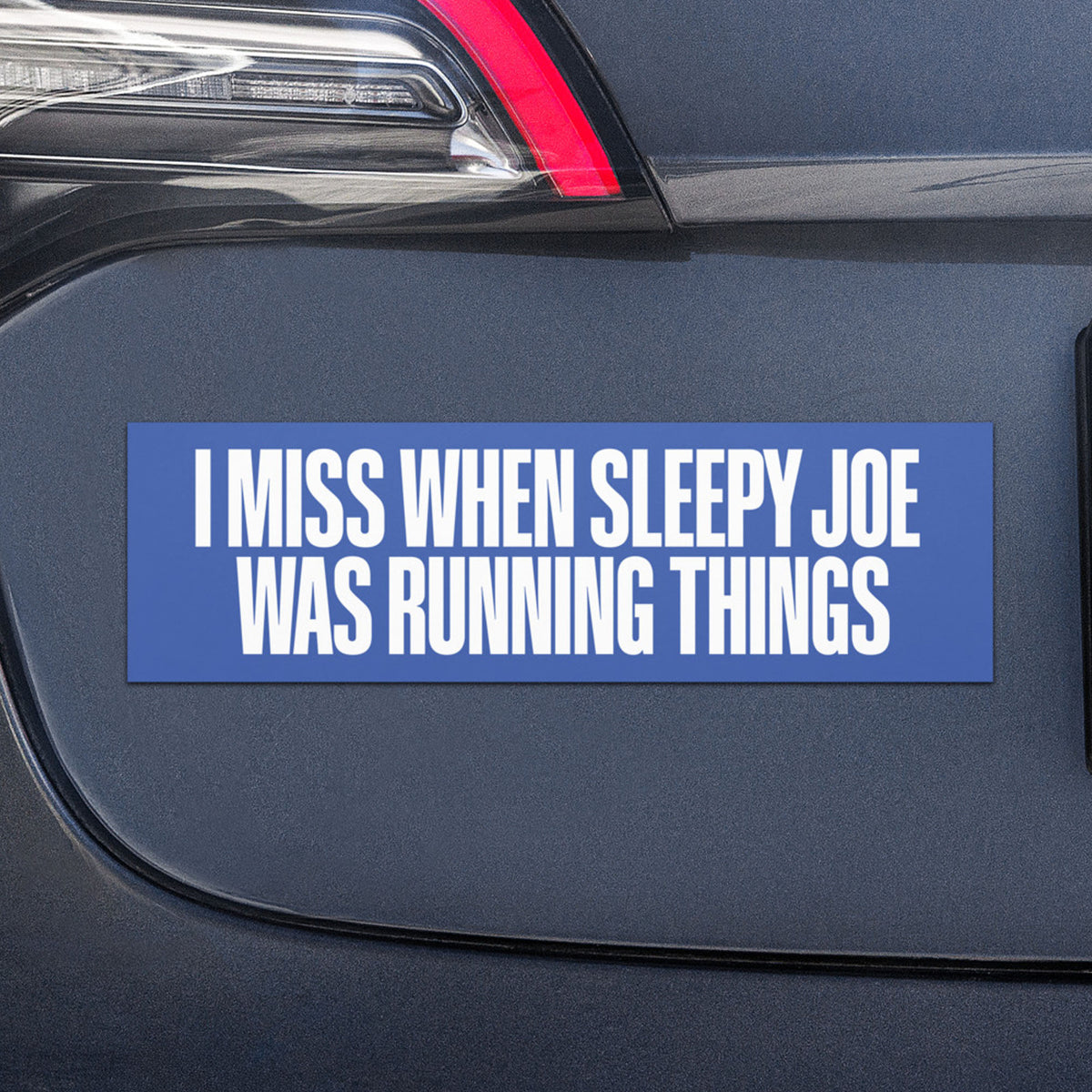 Blue car magnet reading “I Miss When Sleepy Joe Was Running Things” in bold white typography, displayed on the rear of a dark-colored vehicle.
