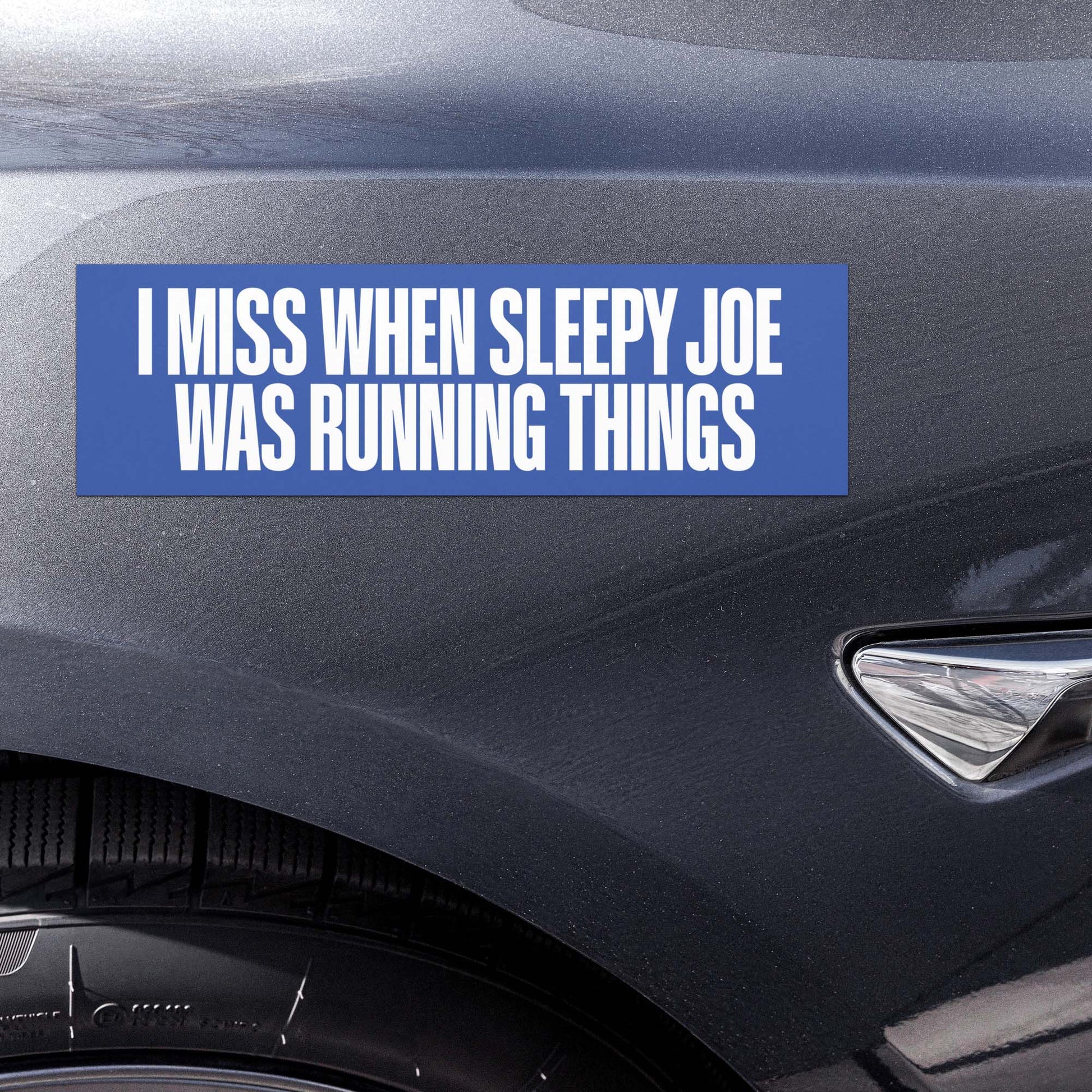 Car magnet displayed on vehicle bumper with bold white text reading “I MISS WHEN SLEEPY JOE WAS RUNNING THINGS” on blue background.