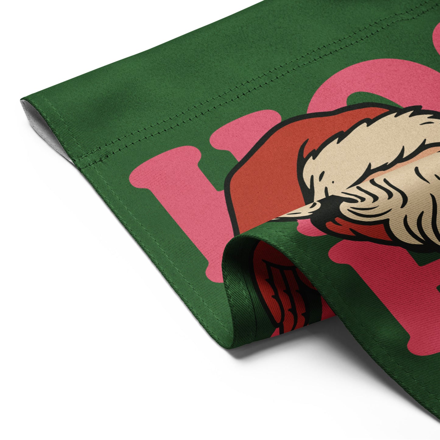 Close-up angle of the folded garden flag, showing stitching, fabric texture, and part of the vintage Santa illustration—progressive holiday decor from Blue Wave USA.